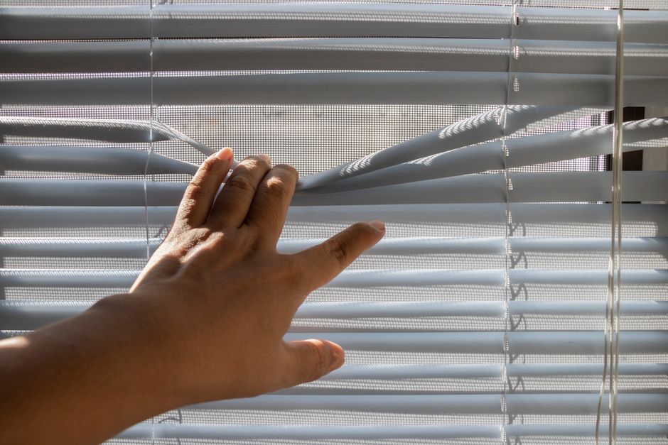 Professional contractor measuring and installing custom window blinds