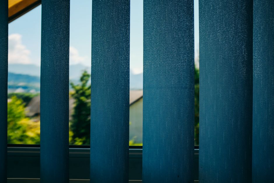Sunlight streaming through modern window blinds